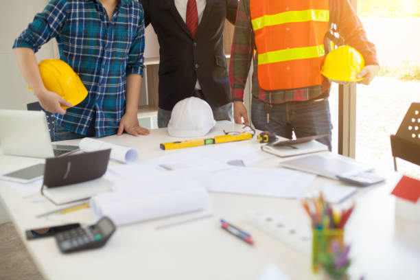 istock Concept Agreement between the employer and architect Nick and desk of Architectural project in construction site or office building with mining light 1149427932