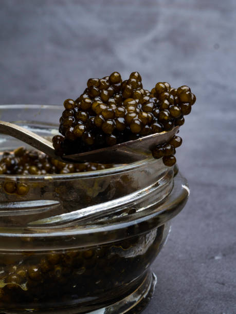 istock Jar with black caviar and a spoon. Free space for text 1149428224