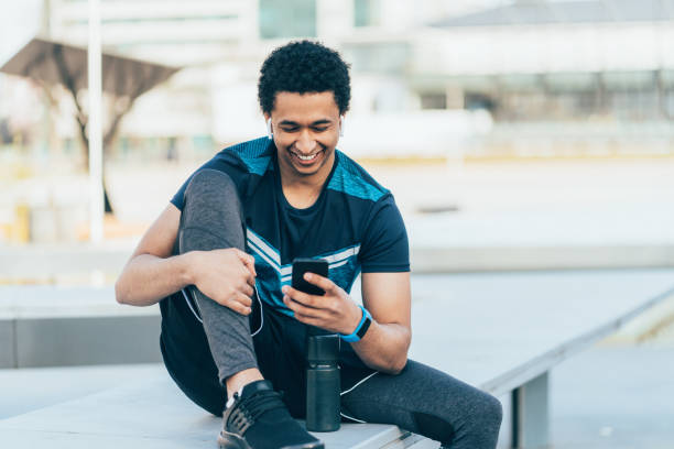 istock Male athlete with smart phone 1149428793