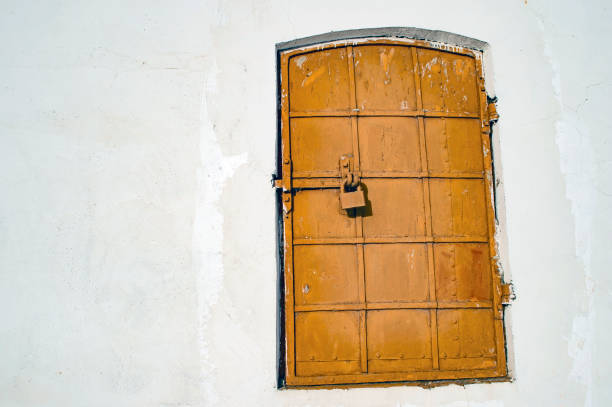 istock Antique iron-bound window with a latch. Background. 1149431031