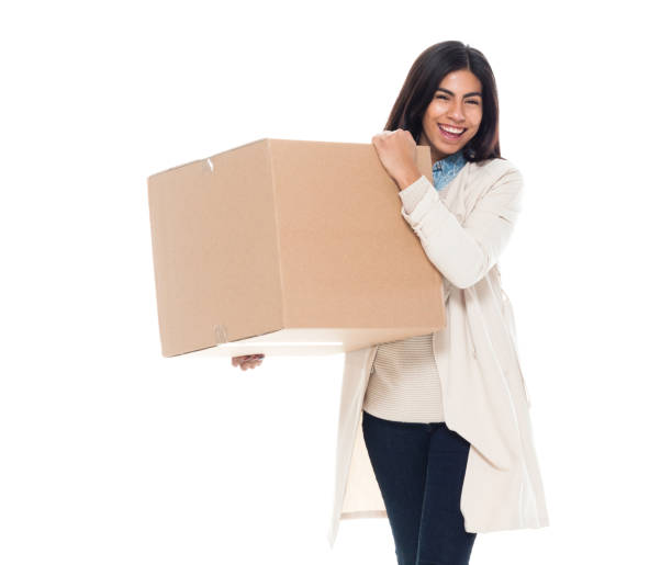 istock Attractive young latino female is holding a box 1149433425