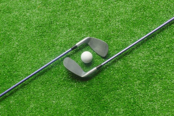 istock Golf balls and golf clubs on green grass 1149434159