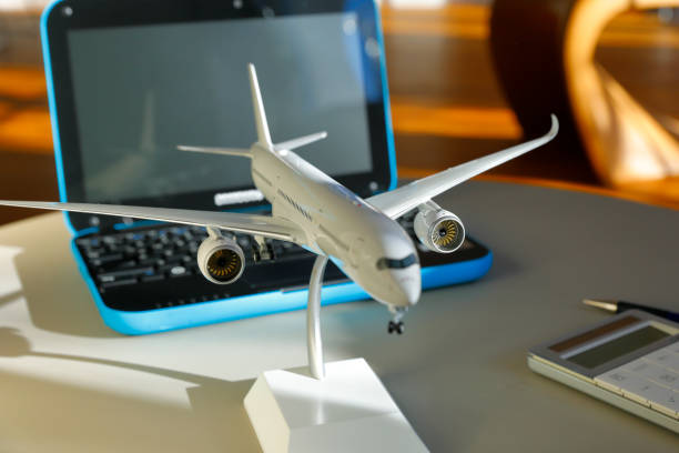 istock Booking a Flight with Laptop and Aircraft model 1149434241