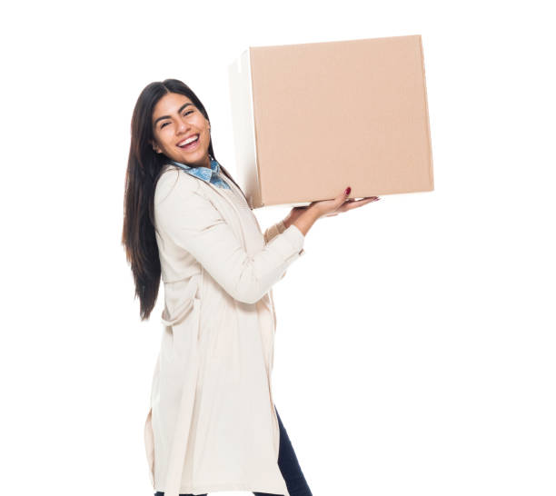 istock Attractive young latino female is holding a box 1149435365