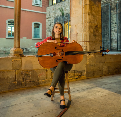 Young musician posing with her cello.