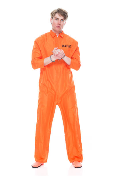 Male prisoner wearing handcuffs Male prisoner wearing handcuffs jumpsuit stock pictures, royalty-free photos & images