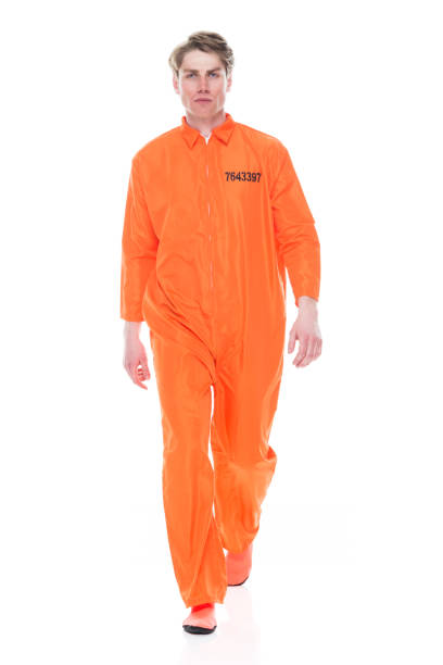 istock Male prisoner wearing orange jumpsuit 1149438781