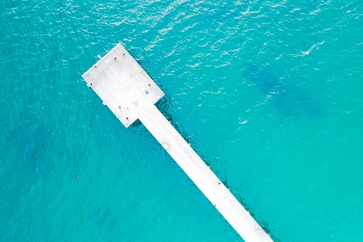 teal water aerial pier and coast California
