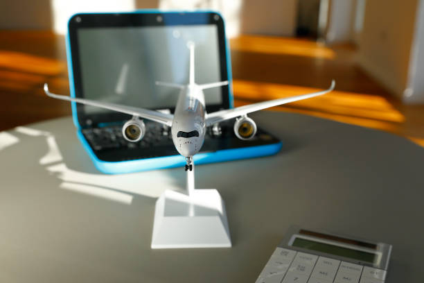 istock Booking a Flight with Laptop and Aircraft model 1149441320
