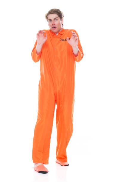 istock Male prisoner wearing orange jumpsuit 1149441436