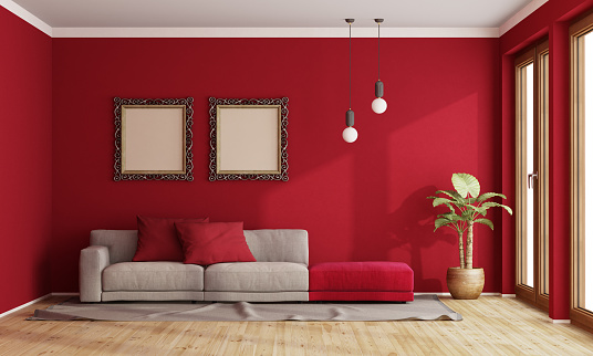 Red living room with modern sofa and old frame on wall - 3d rendering\nthe room does not exist in reality, Property model is not necessary