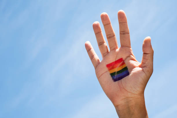 istock person with a rainbow flag in his or her hand 1149445611