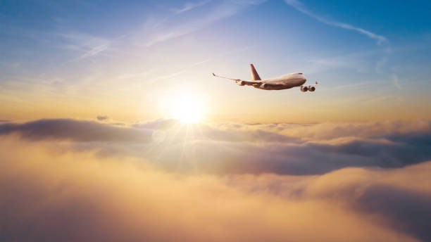 istock Commercial airplane flying over dramatic sunset 1149452708