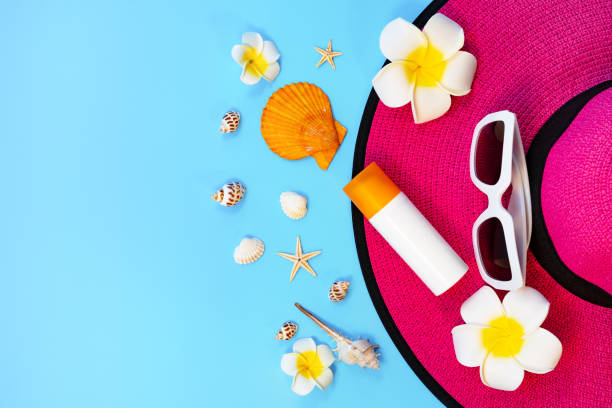 istock Beautiful summer holiday, Beach accessories, sunglasses, hat, sunblock and shells on blue backgrounds 1149453247