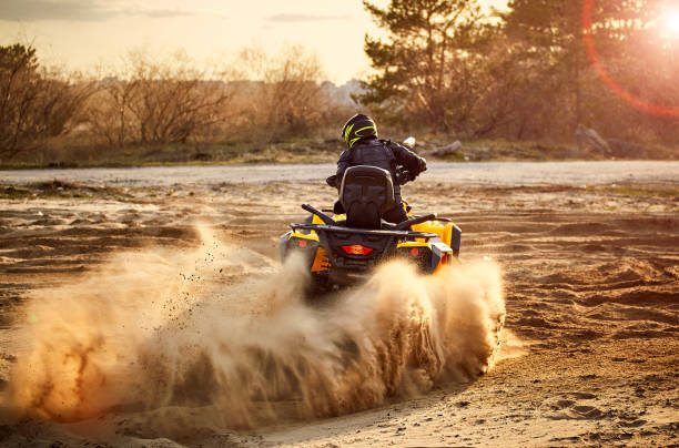 istock Racing powerful quad bike on the difficult sand in the summer. 1149453553