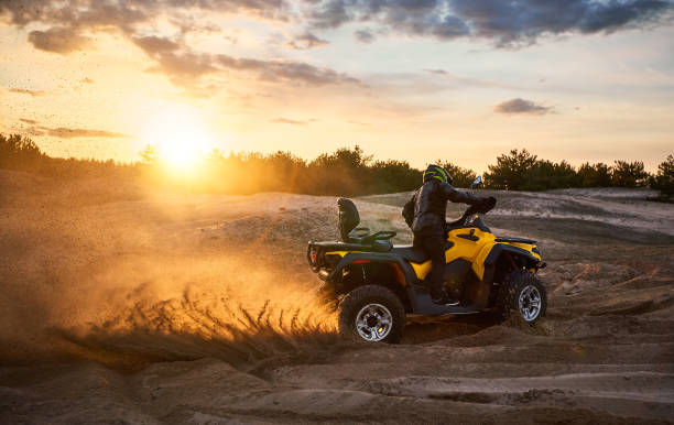 istock Racing powerful quad bike on the difficult sand in the summer. 1149453558