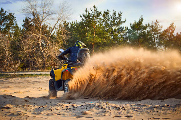 istock Racing powerful quad bike on the difficult sand in the summer. 1149453573