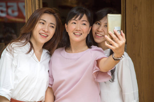 istock asian tea shop hostess taking selfie 1149453908