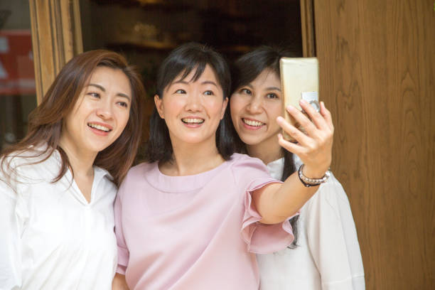 istock asian tea shop hostess taking selfie 1149454101
