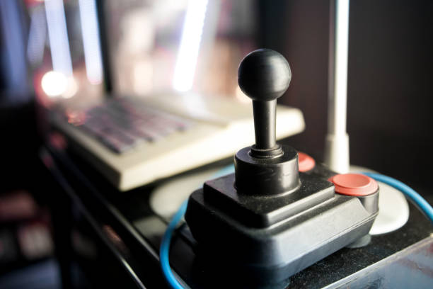 Close up on a joystick with a blurred background in an arcade hall