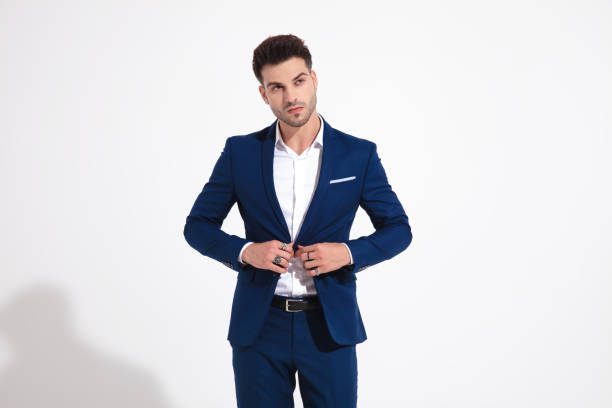 istock Young man looking to the side and fixing his jacket 1149457552