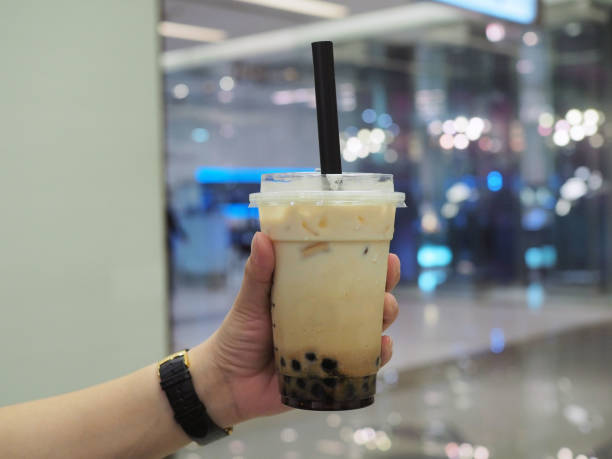 istock Holding a plastic glass of refreshing Taiwanese iced milk tea with bubble (boba). 1149457729