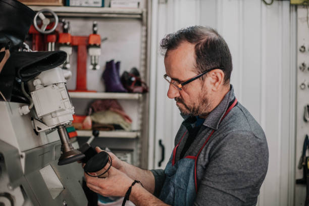 istock Portrait of an authentic cobbler fixing shoes 1149459278