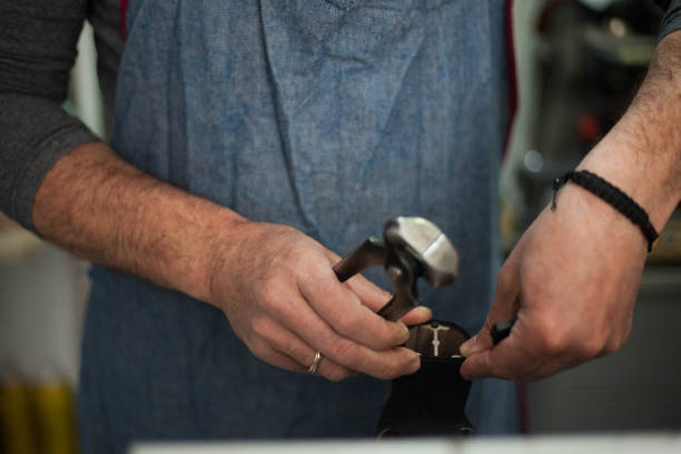 istock Portrait of an authentic cobbler fixing shoes 1149459387