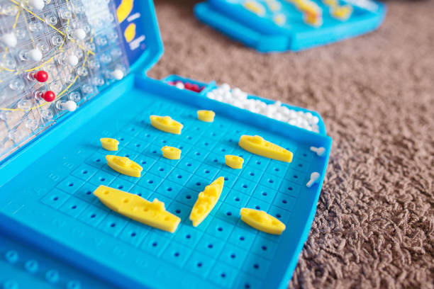 Board game. Battleship. Board game. Children game-sea battle. Toy warships and submarine are placed on the playing field. battleship stock pictures, royalty-free photos & images