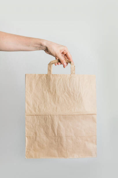 istock Zero waste. Paper shopping bag in women's hand. 1149467215