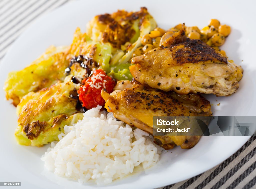 Chicken thighs with  leaves of cabbage  in batter, garbanzo and rice Chicken thighs with  leaves of cabbage  in batter with sauce, garbanzo and rice Appetizer Stock Photo