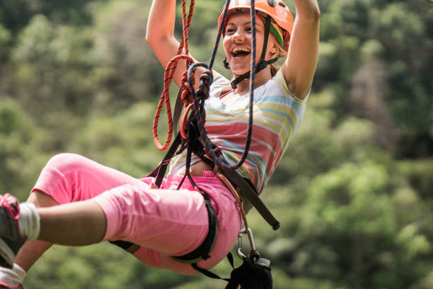 istock Young happy woman having fun while rappelling from a zip line. 1149470247