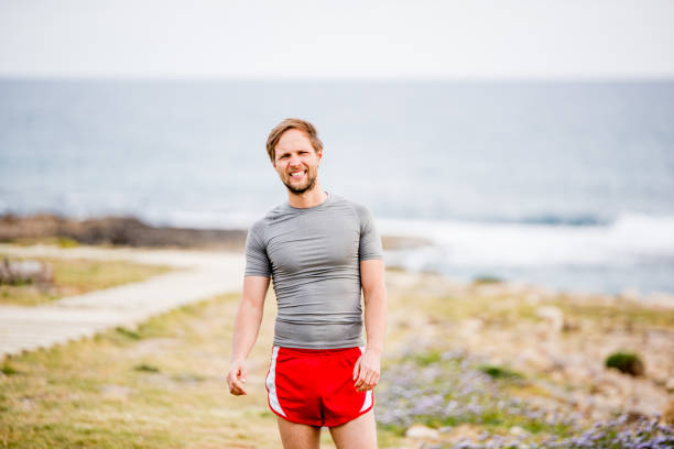 istock Young man feeling tired after a hard exercise by the coastline. 1149475760