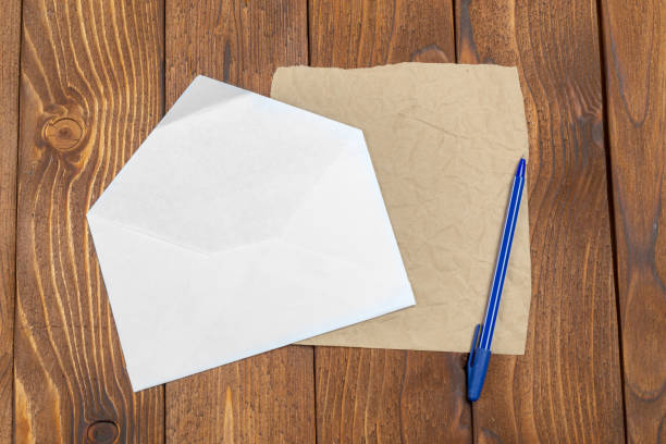 istock Blank Papers and Pen on Wooden Table 1149476916