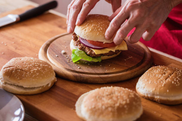 istock Hamburger preparing, fresh made burger at cutting board 1149477687