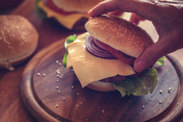 istock Hamburger preparing, fresh made burger at cutting board 1149477832