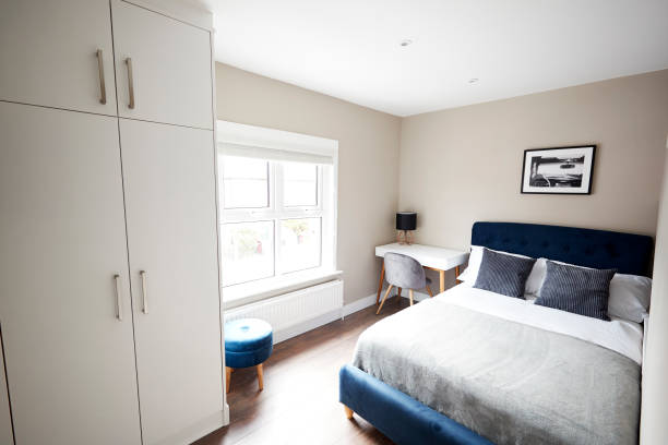 istock Bedroom with bed and wardrobe, looking to window 1149478499