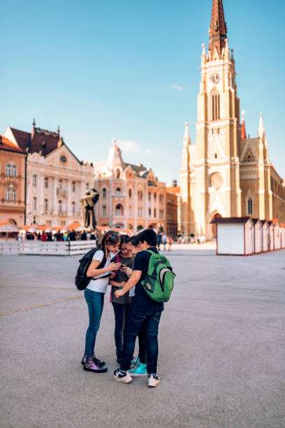 istock Group of classmates looking at smart phone on school excursion 1149481941