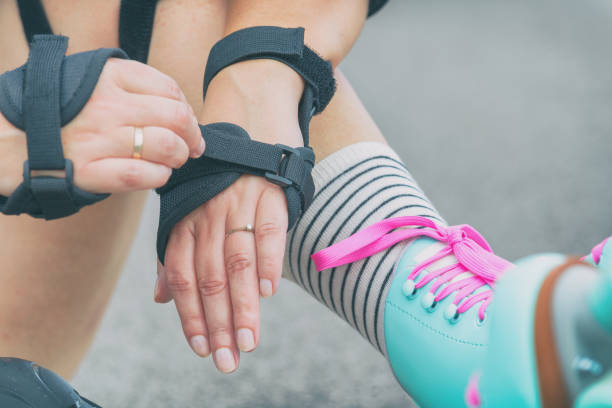 istock Woman rollerskater putting on wrist guards protector pads 1149483025