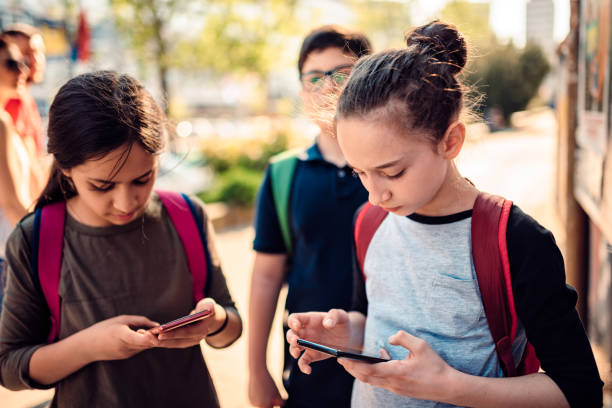 istock School girl using smart phone on the street 1149485272
