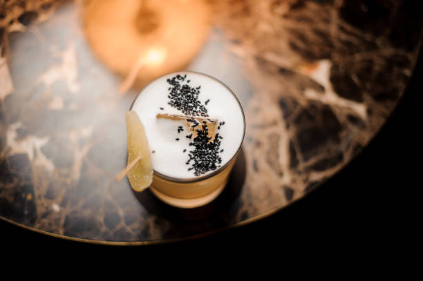 Close-up of an alcohol cocktail on table with lamp