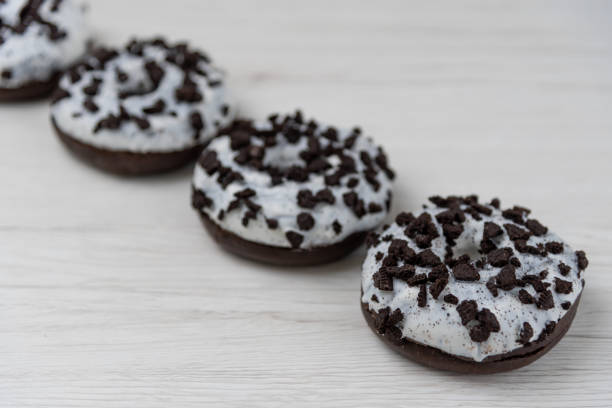 istock Donuts on a white wood background, close-up, selective focus. 1149488461