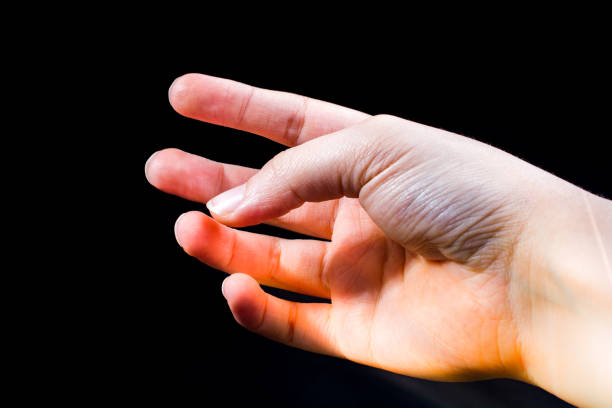 istock Hand and fingers in view on black background 1149491079
