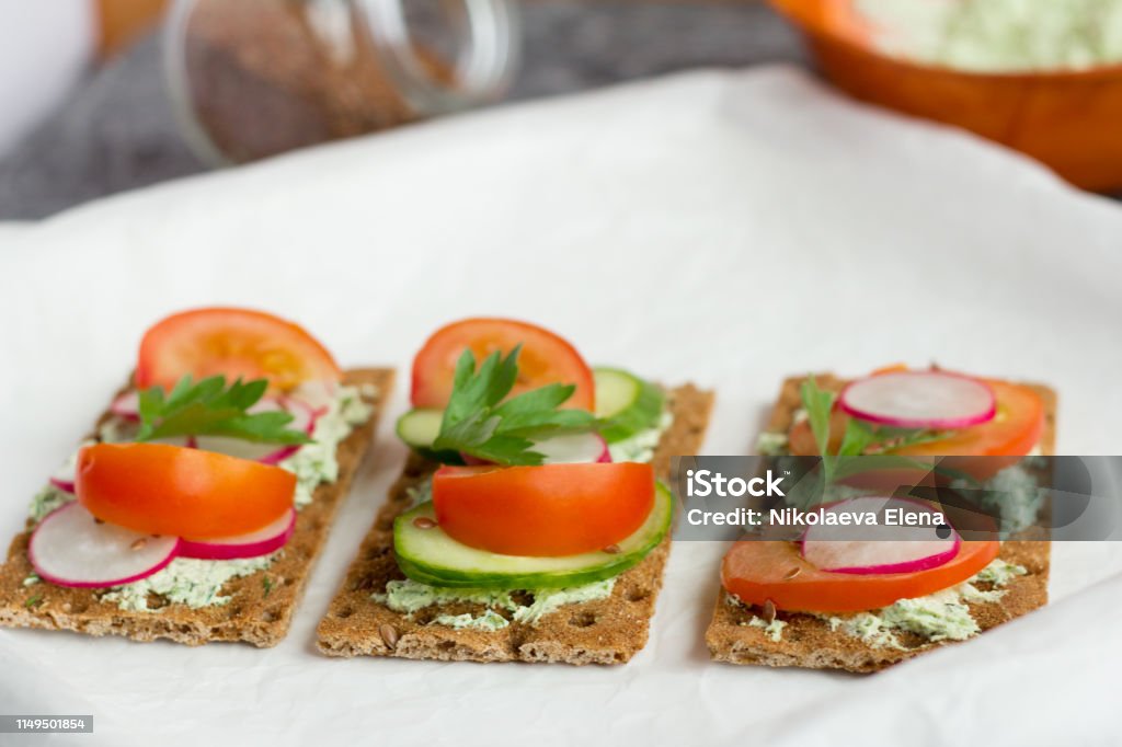 delicious diet sandwiches with cottage cheese with herbs and vegetables on a white background Bread Stock Photo