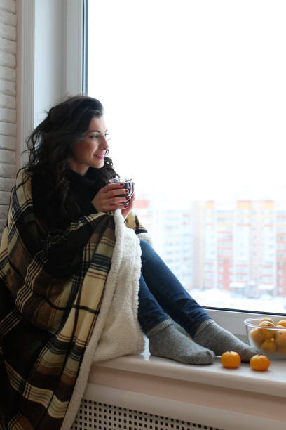 istock A young woman look on the window 1149503998