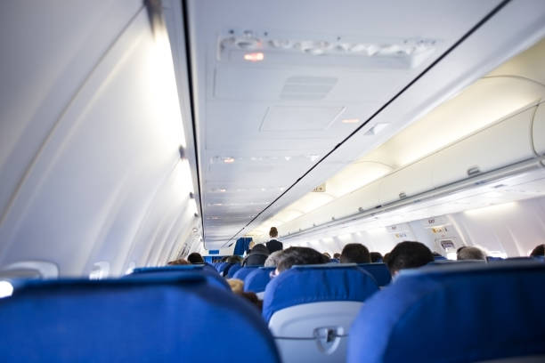 istock Cabin inside the plane, air condition, lights and signs panel above the seat 1149504070