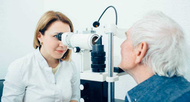 istock Senior man visiting optician, eye exam at clinic 1149504513
