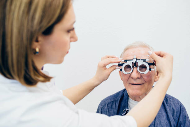 istock optometrist making an eye test to a senior man.Visual impairment aged people 1149504518