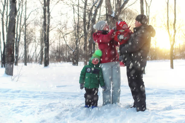 istock Young family in winter park 1149513110