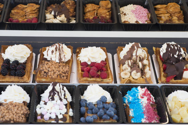 istock Different types of appetizing waffles with fruits, cream and chocolate 1149513270